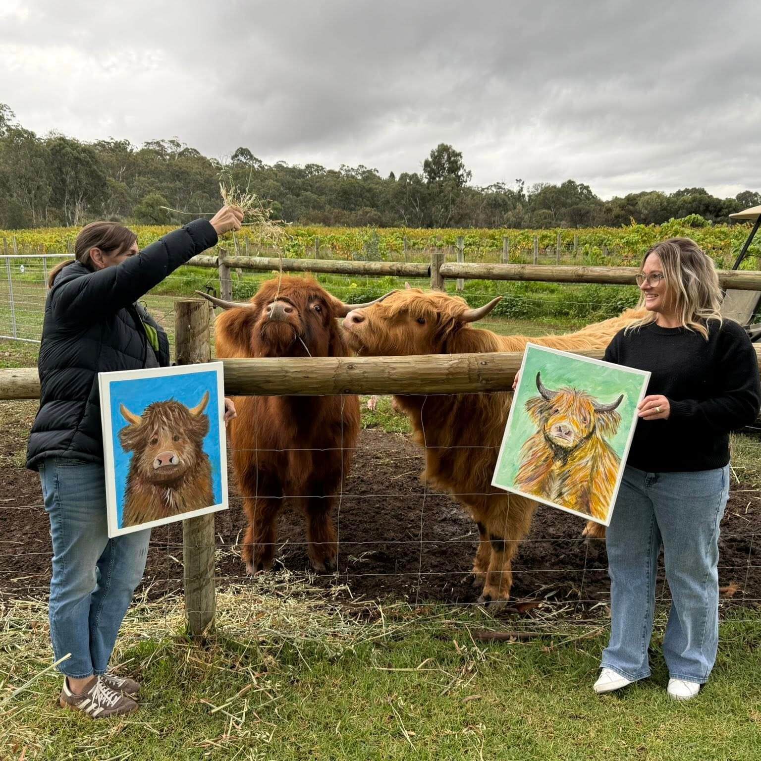 Highland Cows and guests with artwork